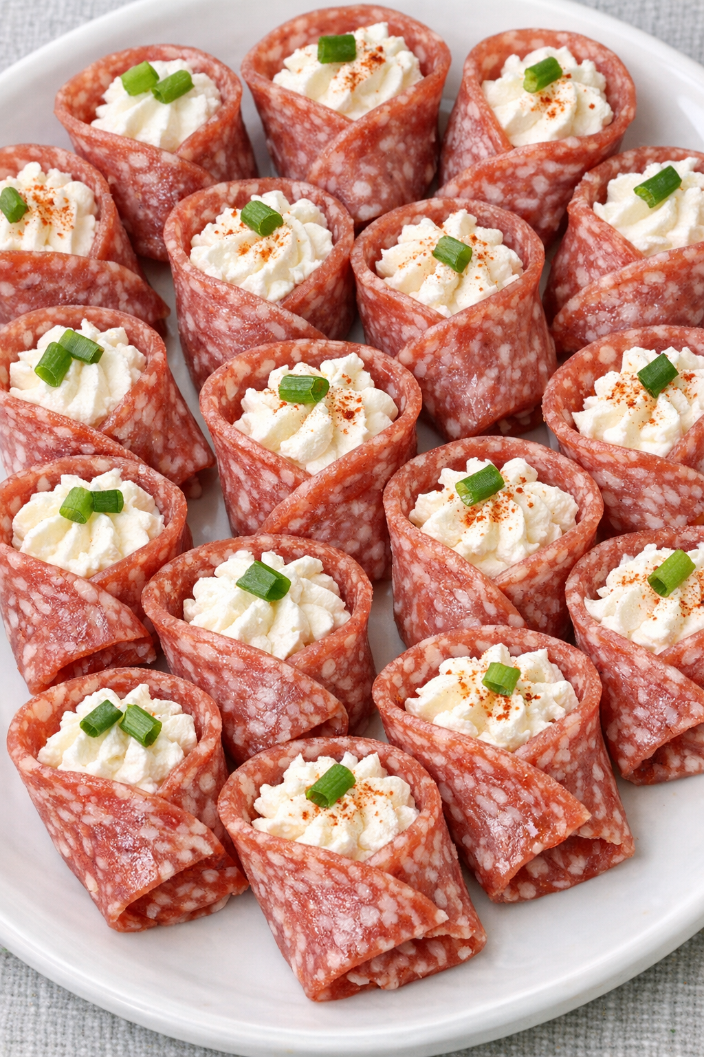 Low carb cream cheese salami bites on a serving platter