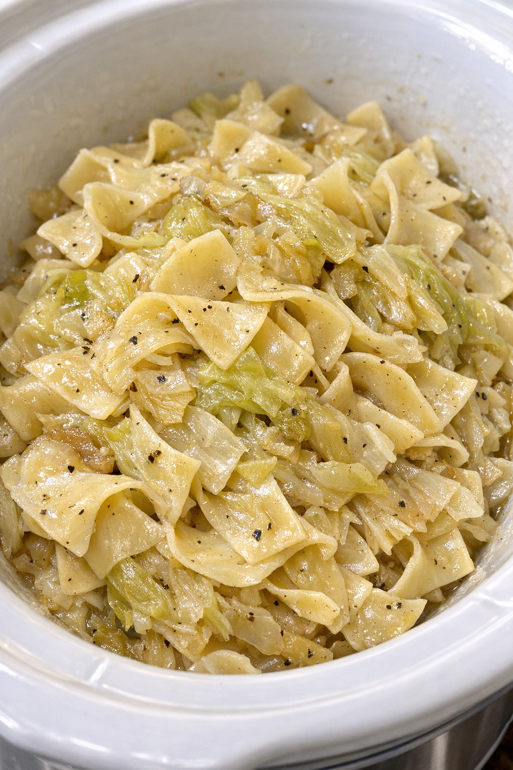 Slow cooker Amish cabbage noodles in a white slow cooker