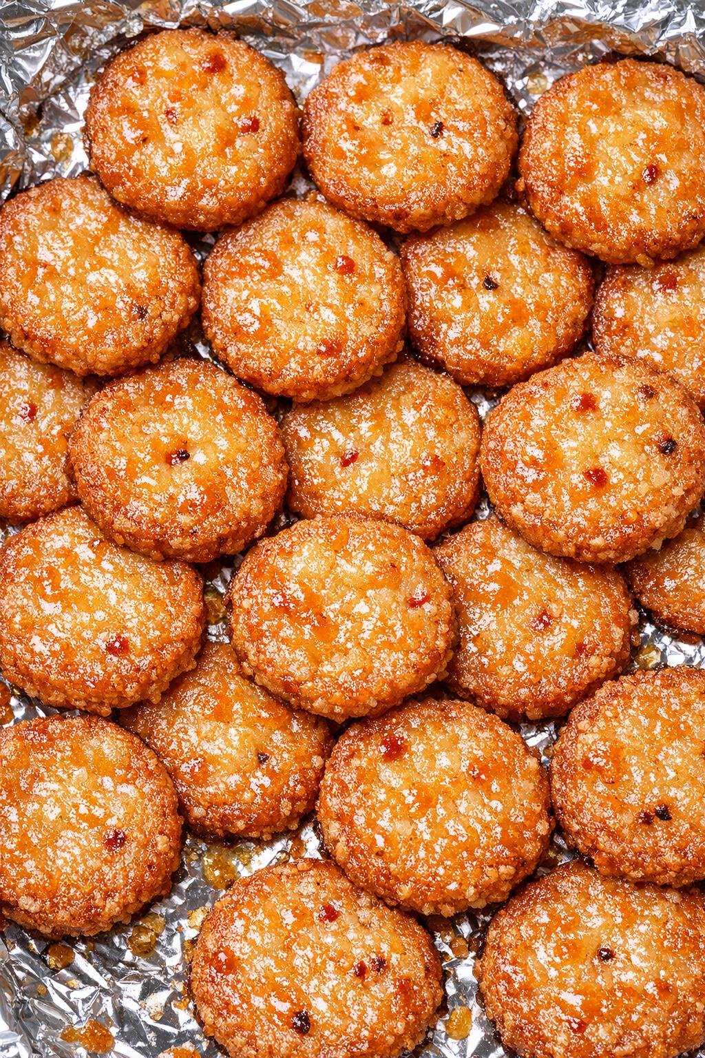 Southern 3-ingredient spicy cheese pennies on a foil-lined baking tray