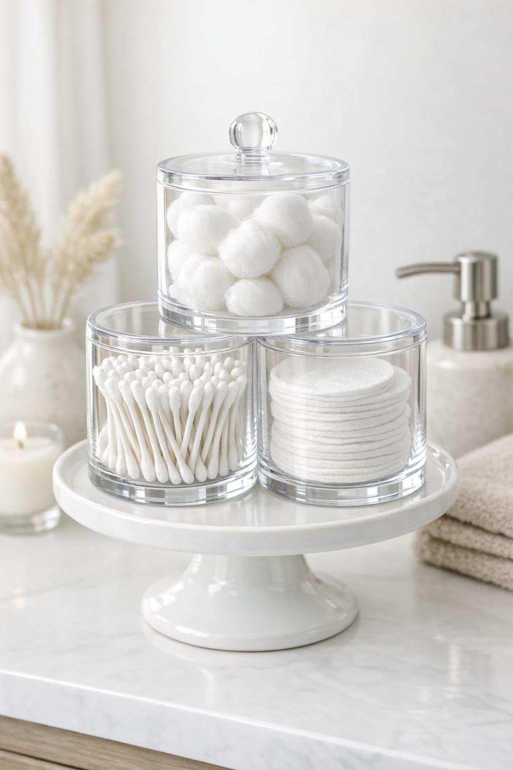 Finished acrylic canister cotton dispenser on a white ceramic cake stand