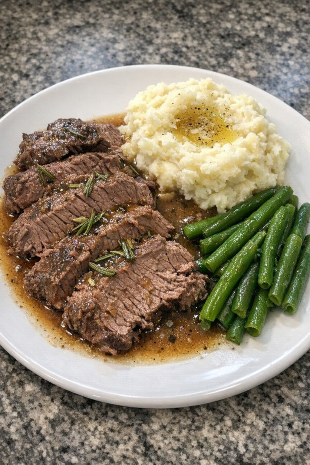 Finished rosemary beef plated with its cooking juices
