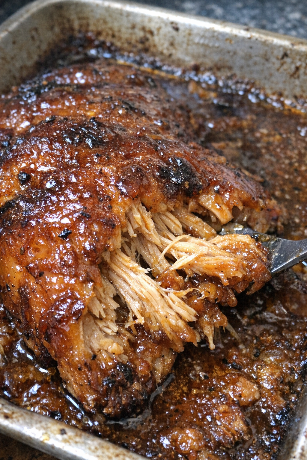 Roasted glazed protein in a metal baking sheet