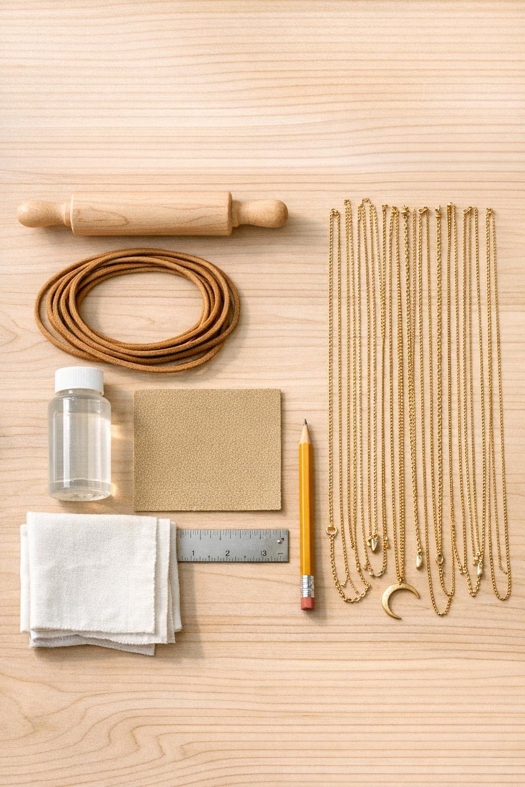 Materials for a rolling pin necklace display laid out on a table
