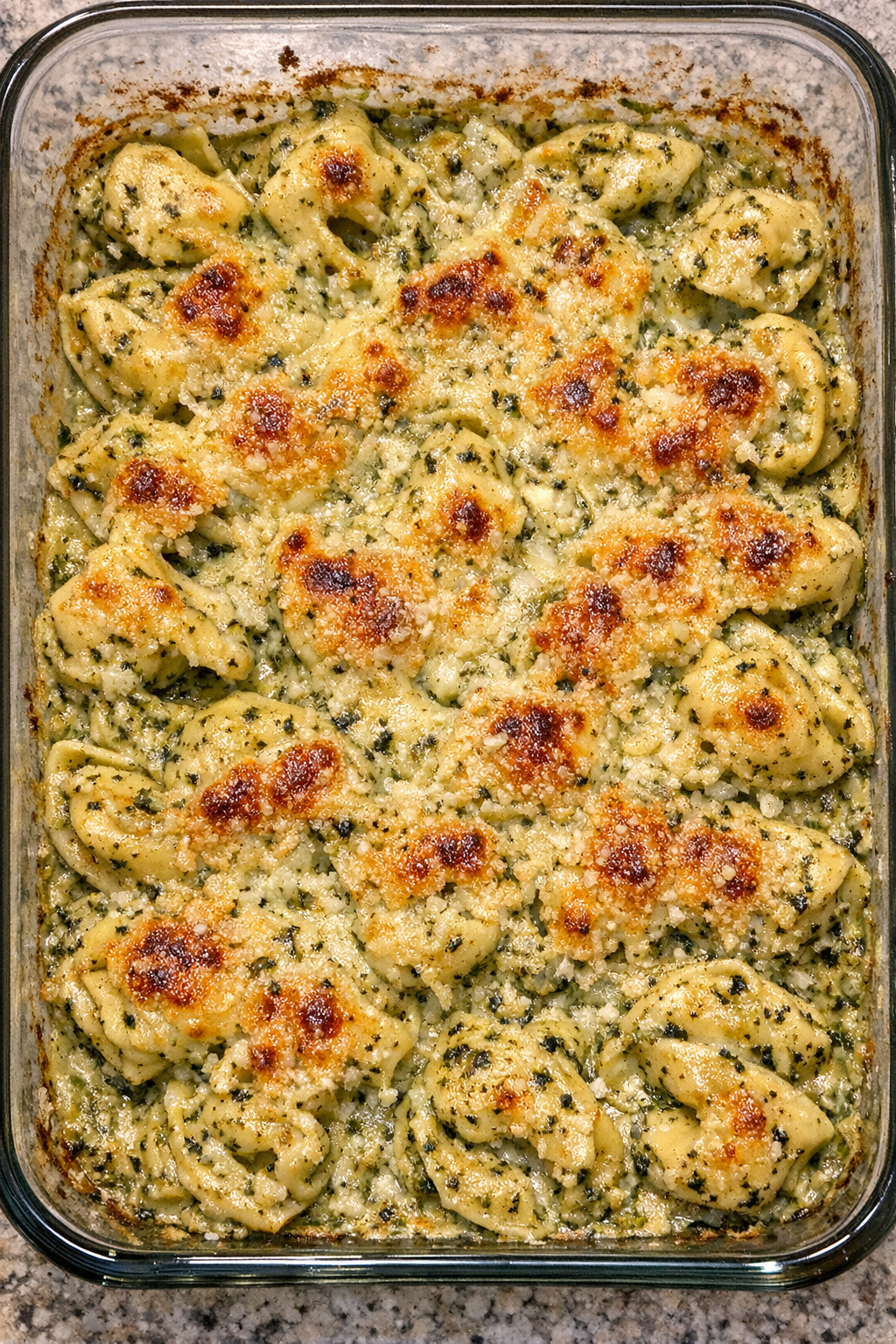 Creamy pesto tortellini bake in glass dish