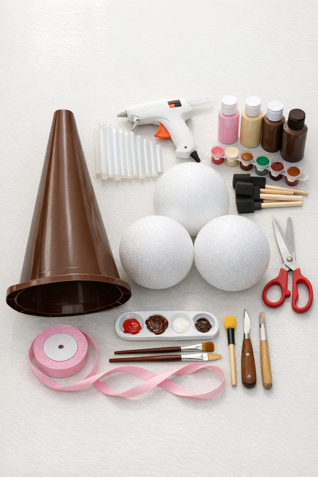 Materials for a giant ice cream cone door hanger laid out on a table