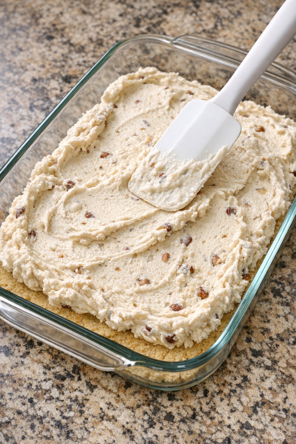 Butter pecan ice cream spread over the cookie layer