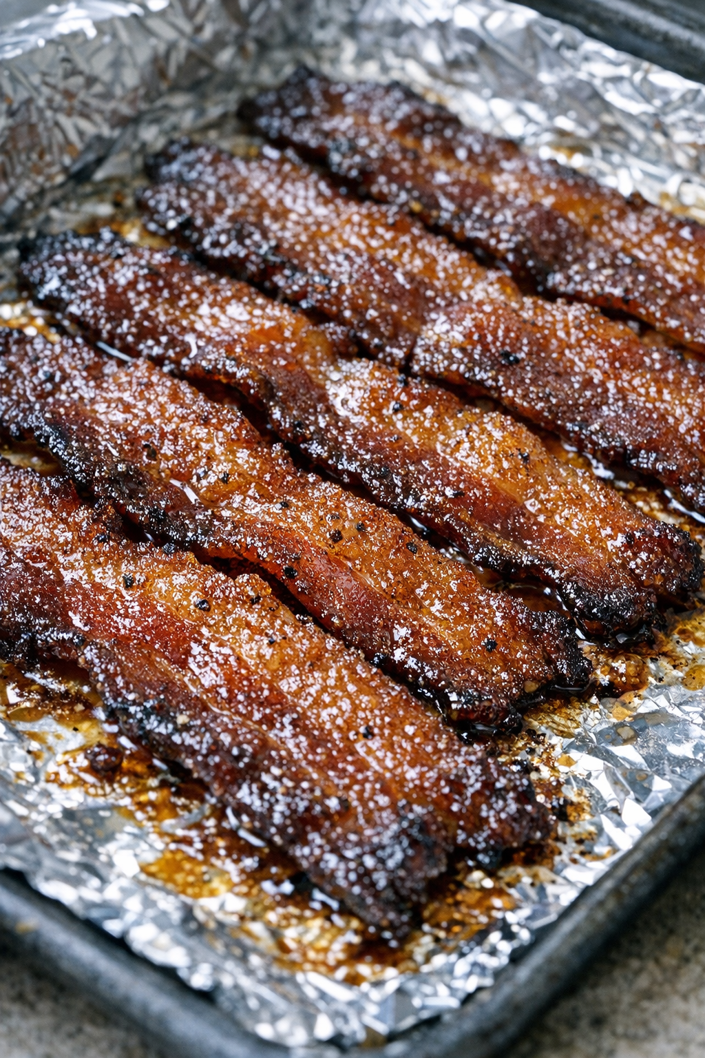 Southern 3-ingredient candied bacon on a foil-lined baking tray