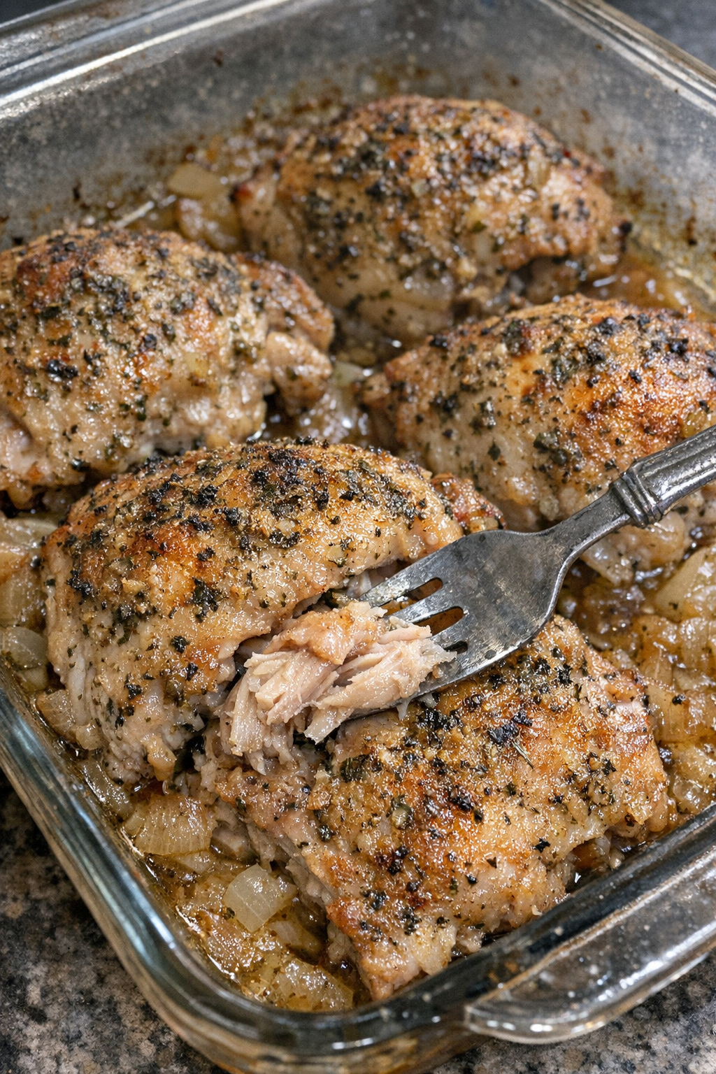 Herb-crusted chicken thighs in a baking dish