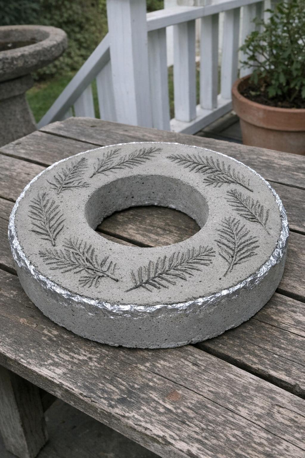 Concrete wreath with evergreen impressions on a porch