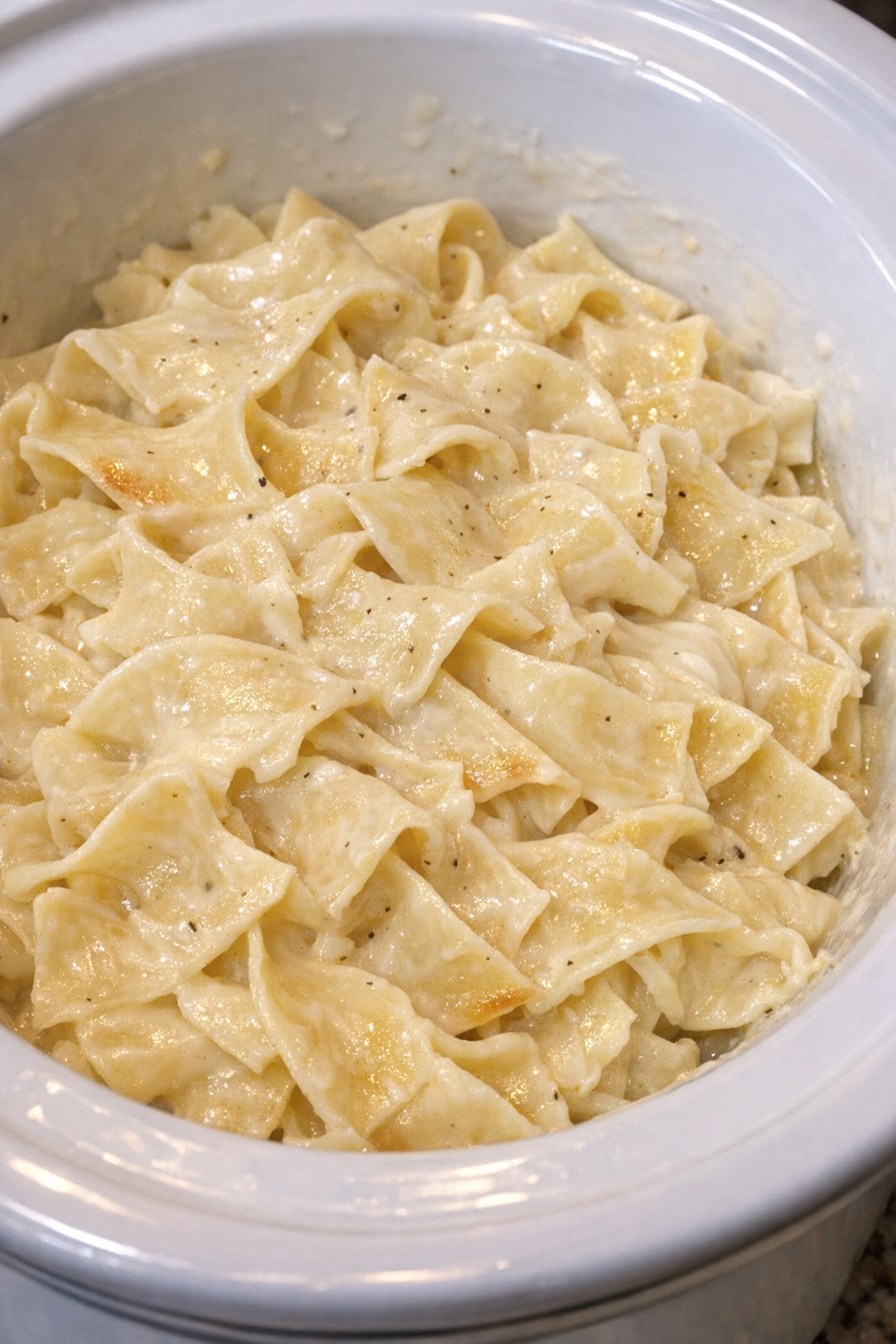 Creamy Amish buttermilk noodles in a white slow cooker