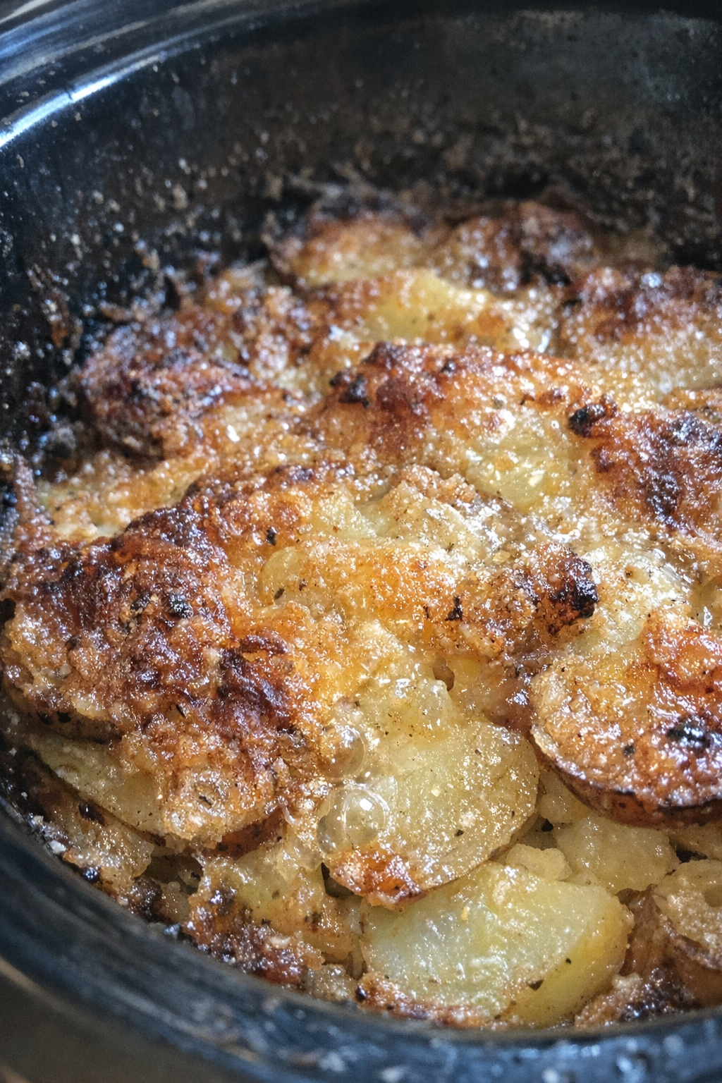 Glossy russet and golden craggy surface bubbling bake in a slow cooker