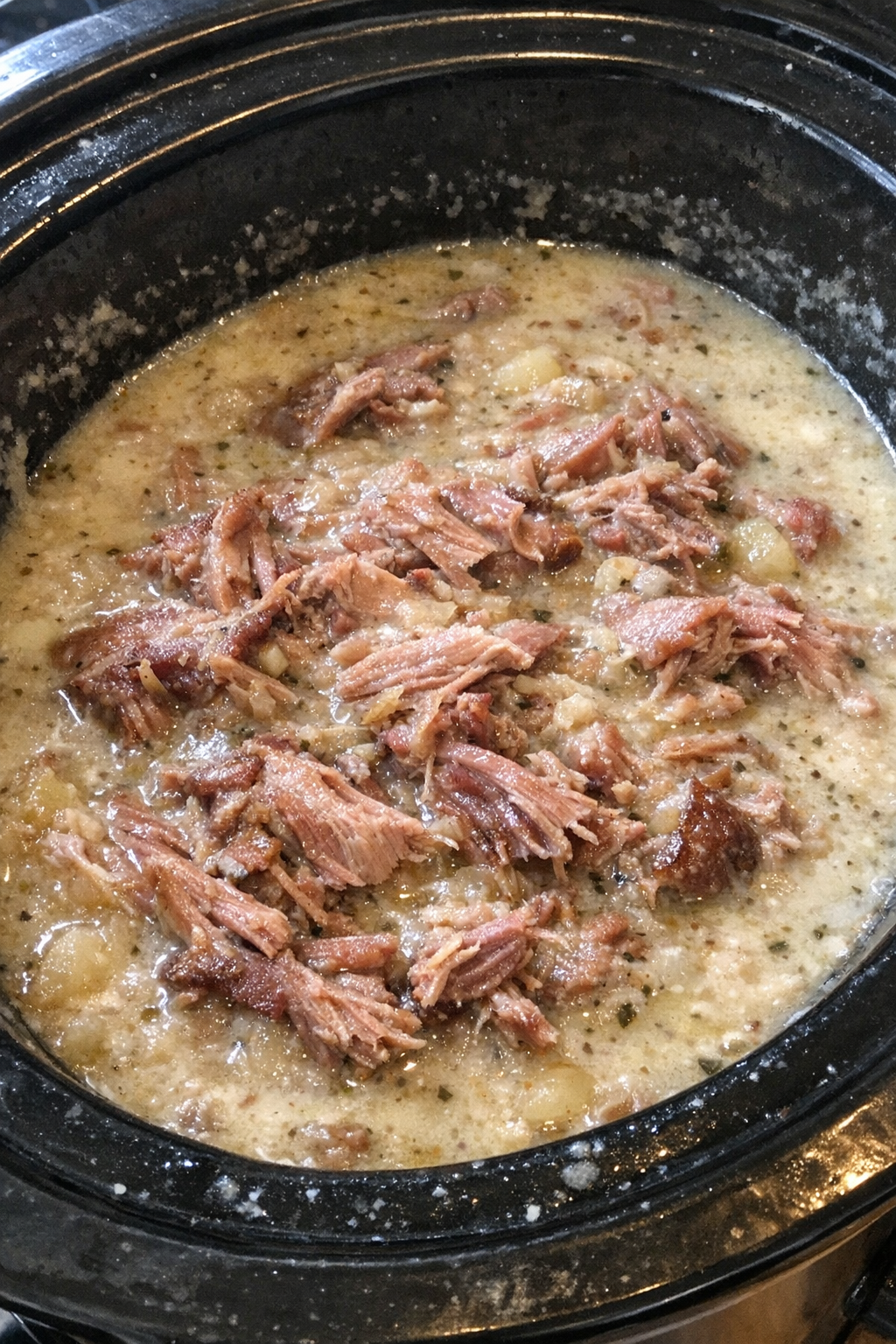 Slow cooker ham hock comfort dish in a creamy savory broth