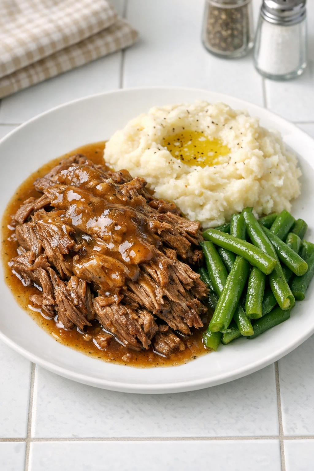 Finished Amish butter beef plated with buttery sauce