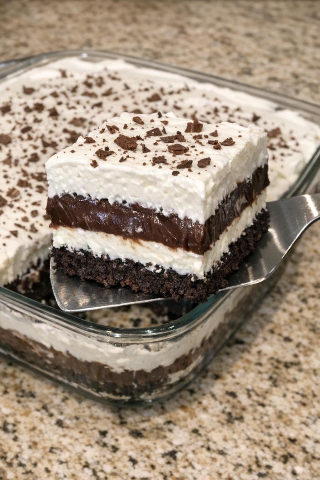 Layered chocolate dessert in a glass casserole dish