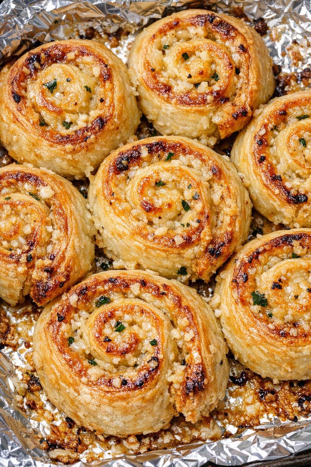 Southern 3-ingredient savory garlic pinwheels on a foil-lined baking tray