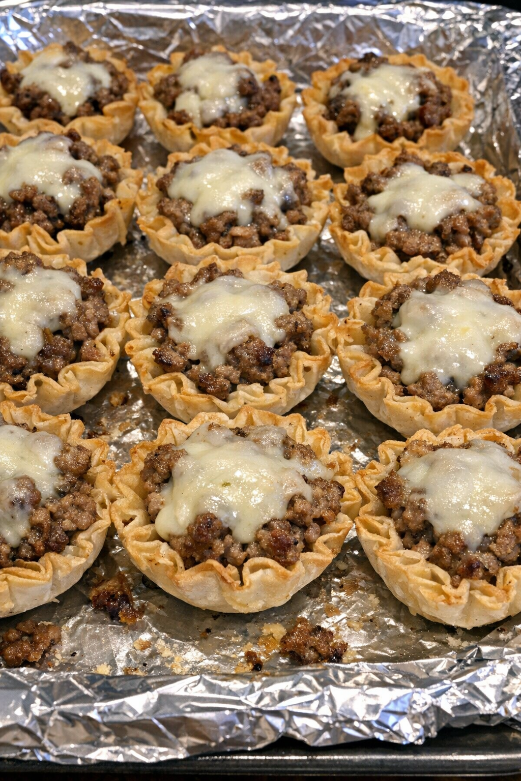 Oven baked beef phyllo cups on a baking sheet
