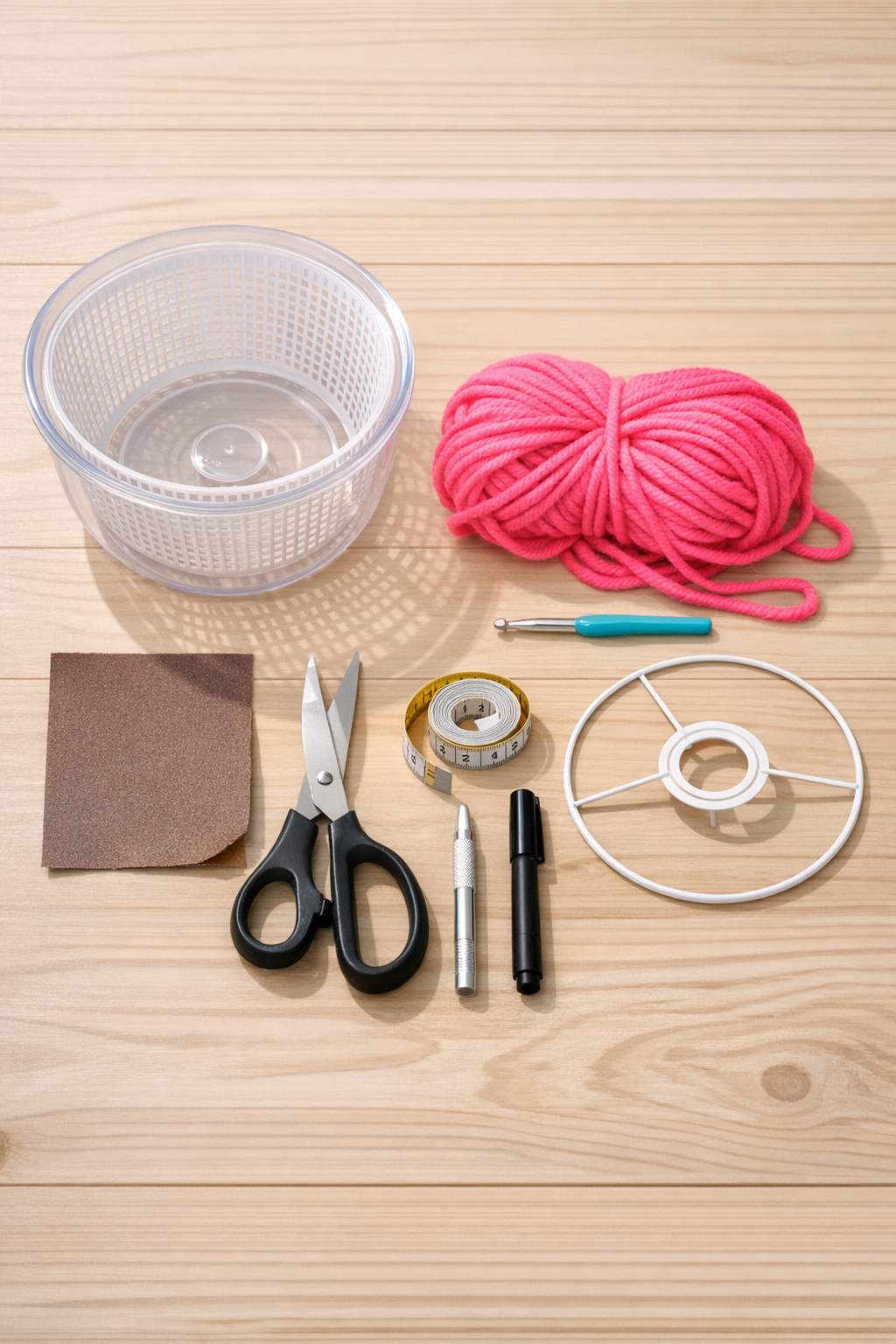 Materials for the crochet salad spinner lamp shade laid out on a table