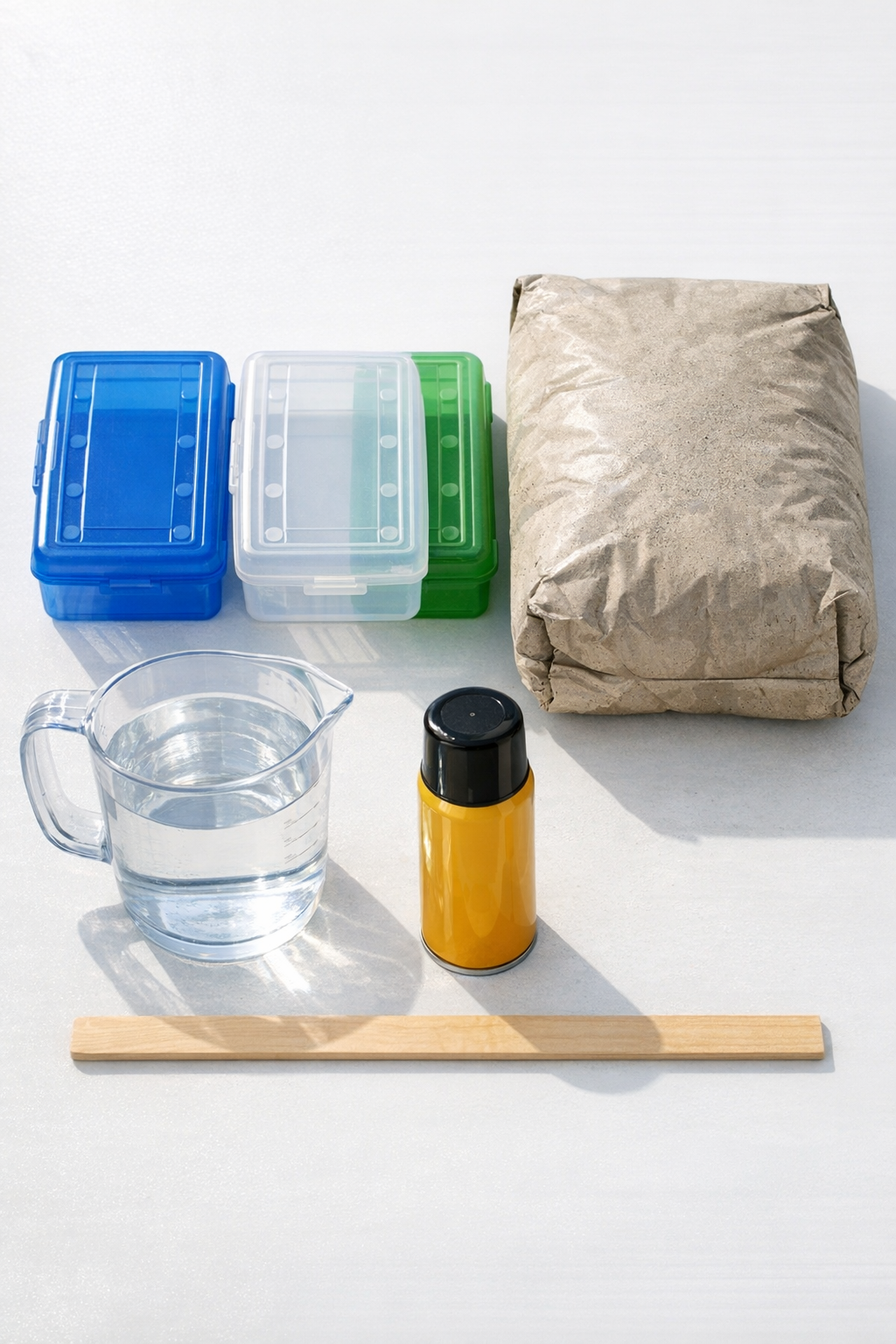 Materials for making concrete yard blocks laid out on a work surface