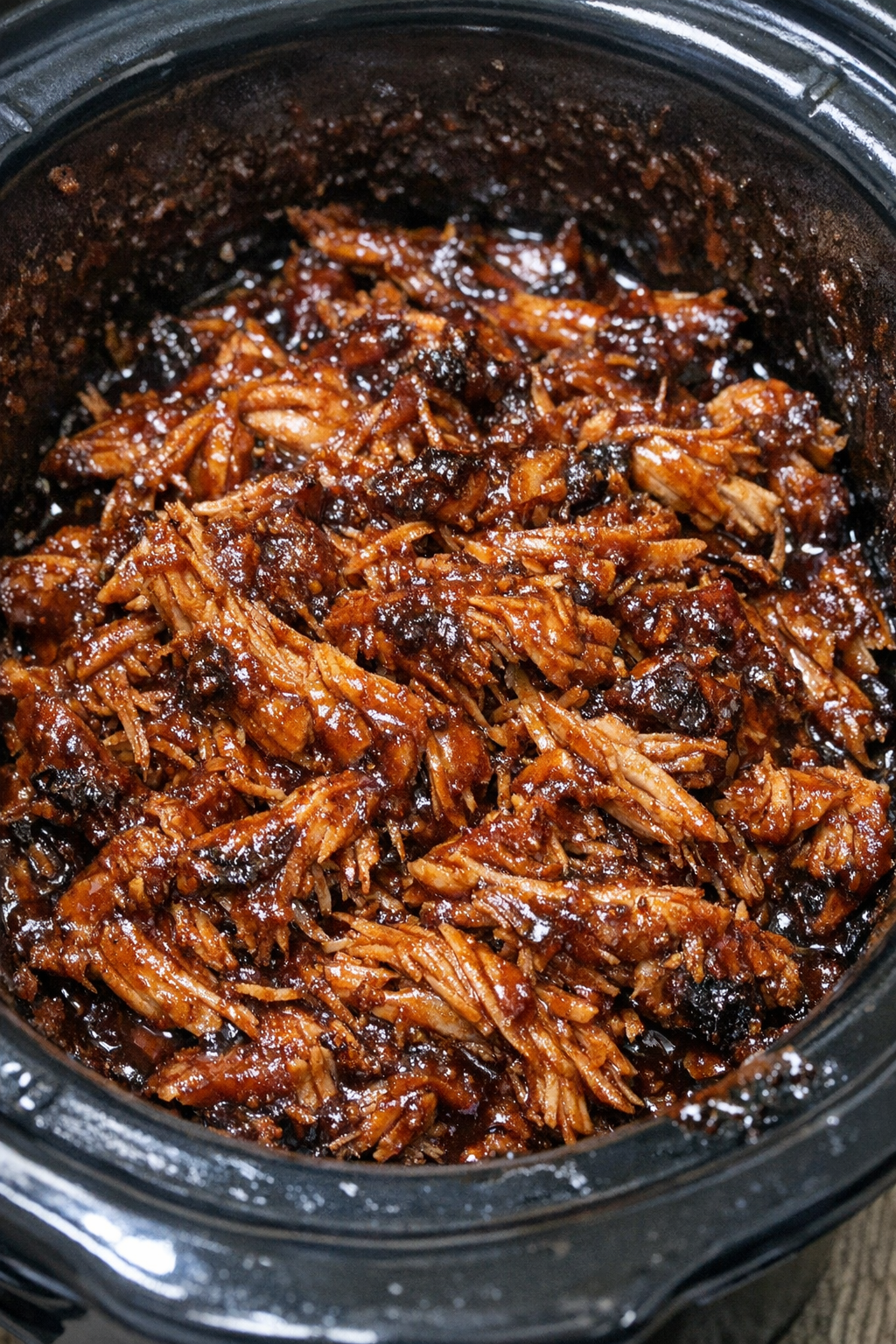 Slow cooker Amish BBQ chicken in a black slow cooker