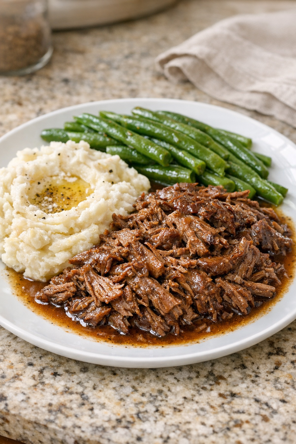 Finished Amish cinnamon beef plated with mashed potatoes