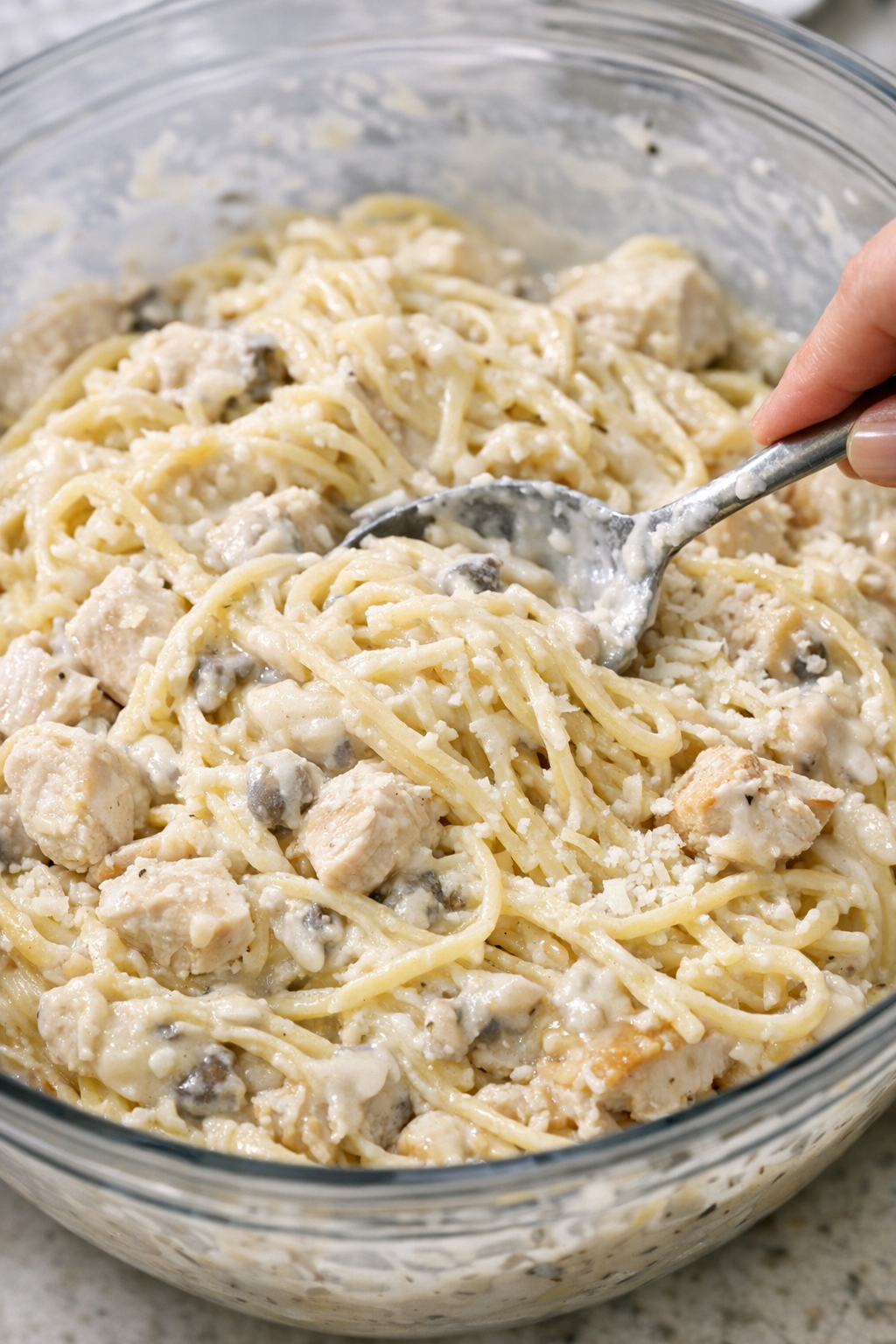 Chicken tetrazzini mixture being combined in a bowl