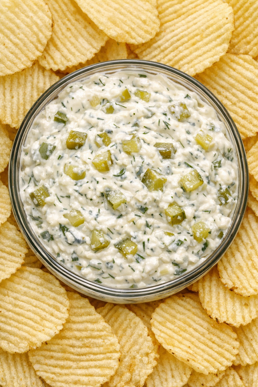 Southern 4-ingredient dill pickle dip in a glass bowl with potato chips