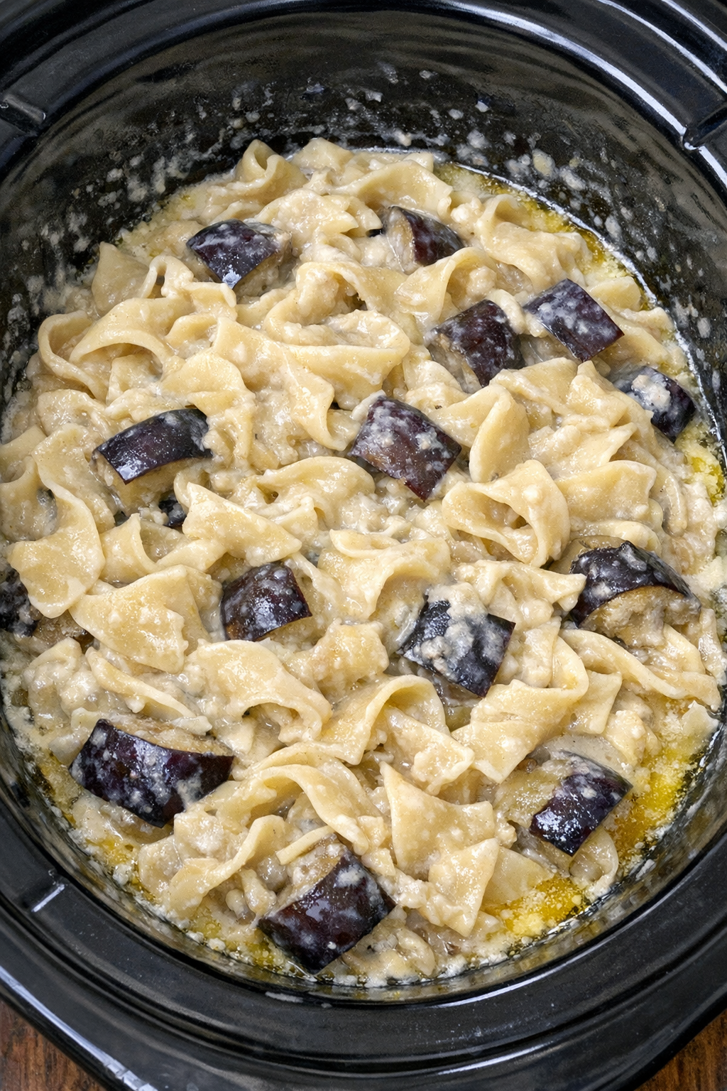 Slow cooker Amish eggplant cream noodles in a black slow cooker