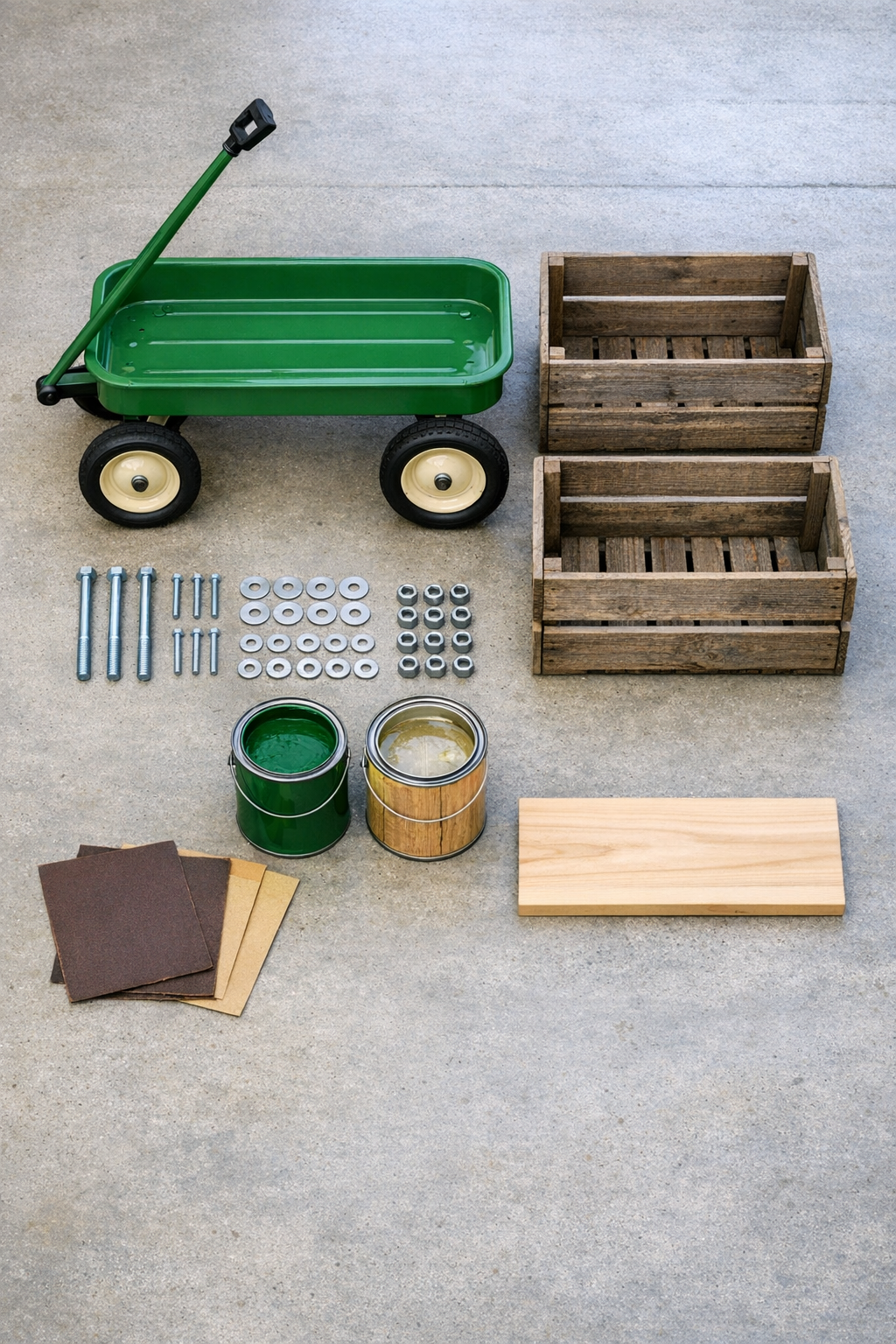 Materials laid out for building an outdoor bar cart from wooden crates and a vintage wagon frame