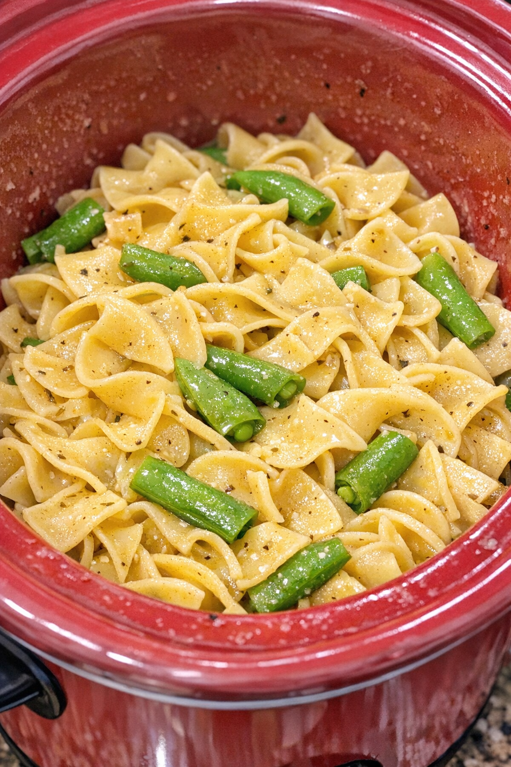 Slow cooker Amish snap pea noodles in a red slow cooker