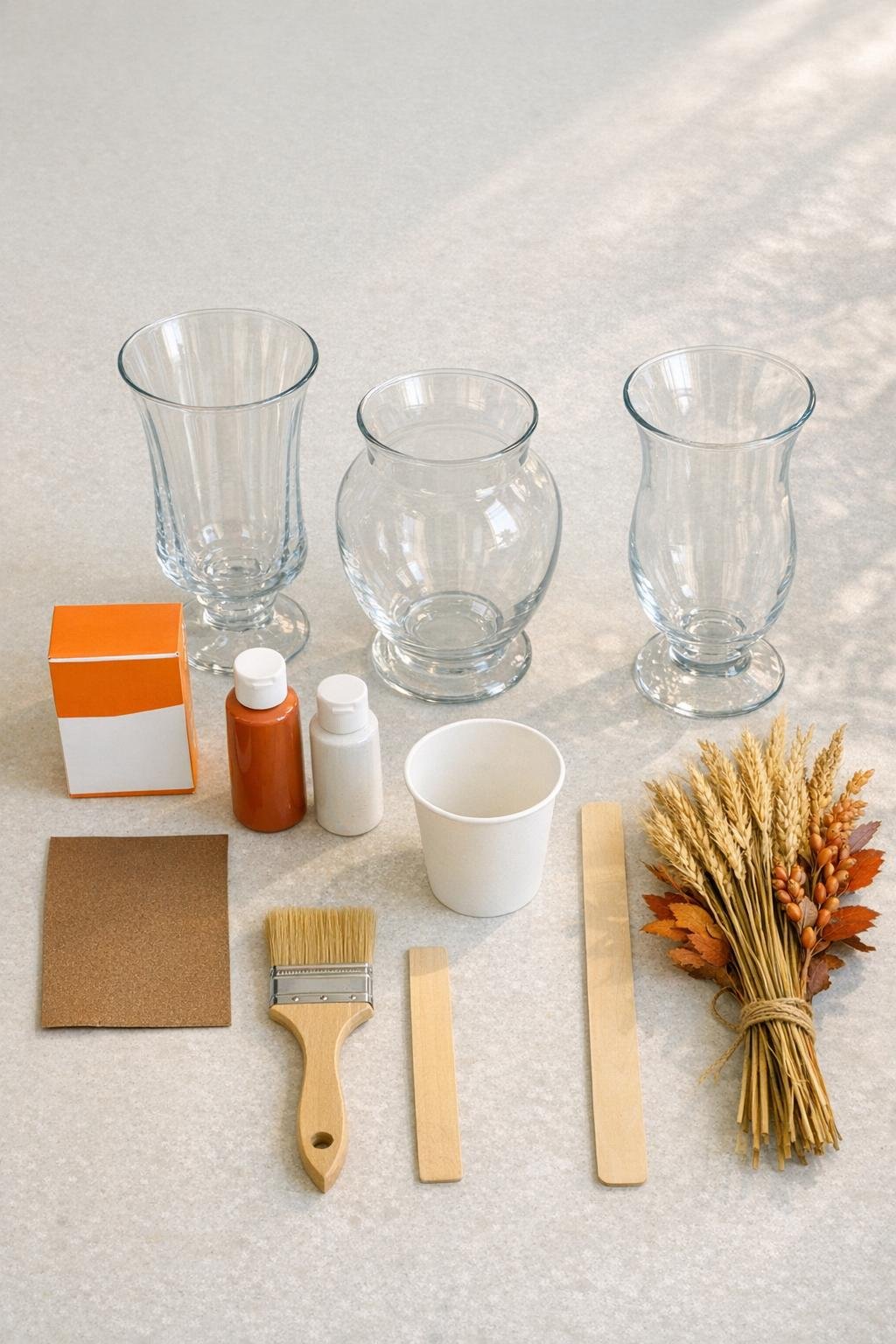 Materials for painting thrifted glass vases with baking soda paint