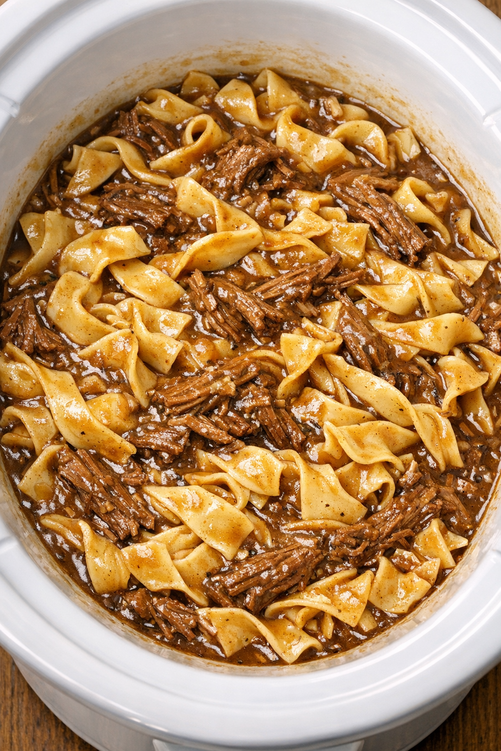 Egg noodles cooking in beef gravy