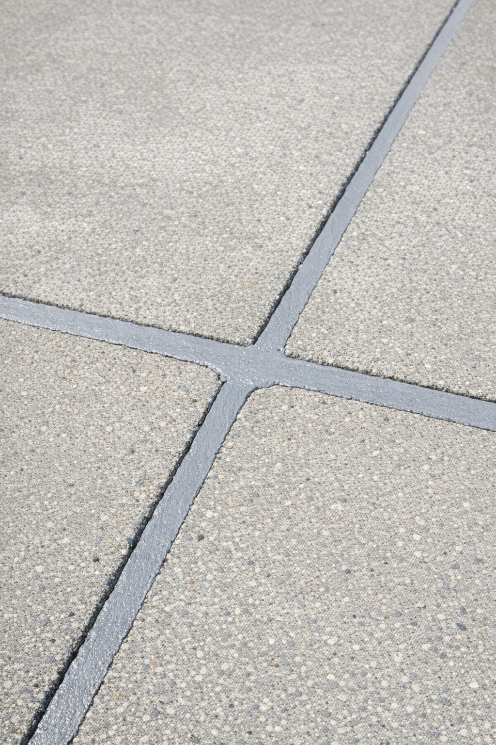 Finished driveway repair with smooth filled cracks