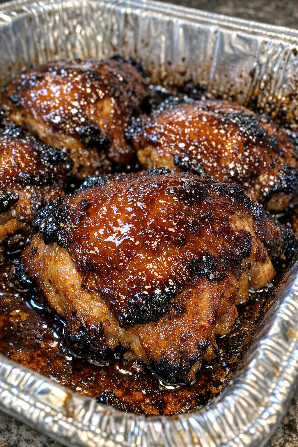 Roasted protein with dark amber glaze in a baking sheet