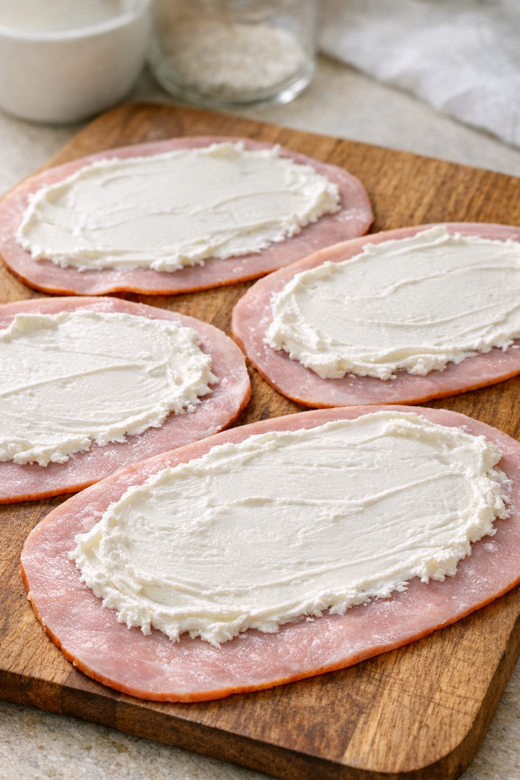 Cream cheese spread over slices of ham