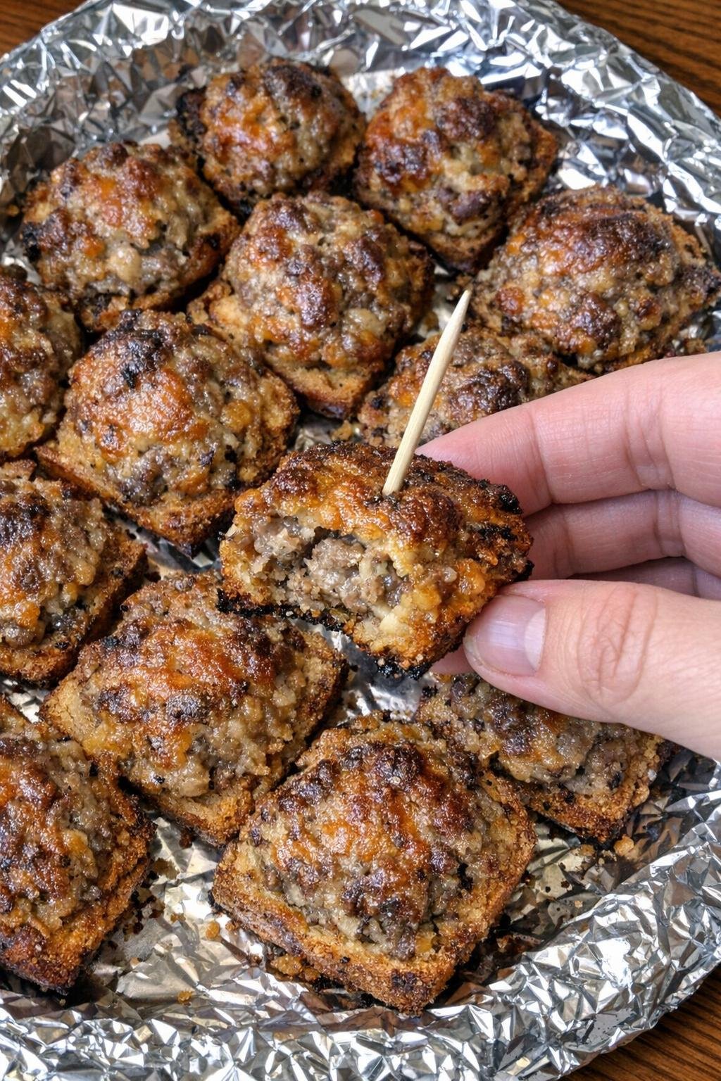 Close-up of sausage garfield bites on a foil-lined platter
