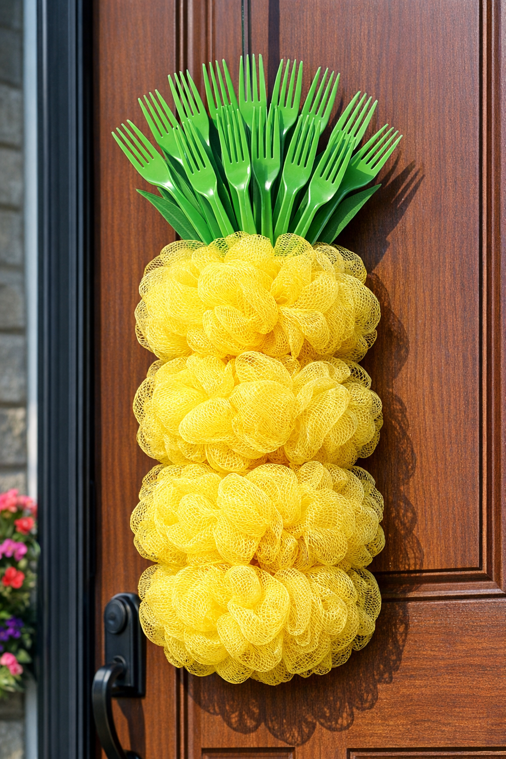 Finished giant summer pineapple front door hanger made from yellow loofahs and green plastic forks