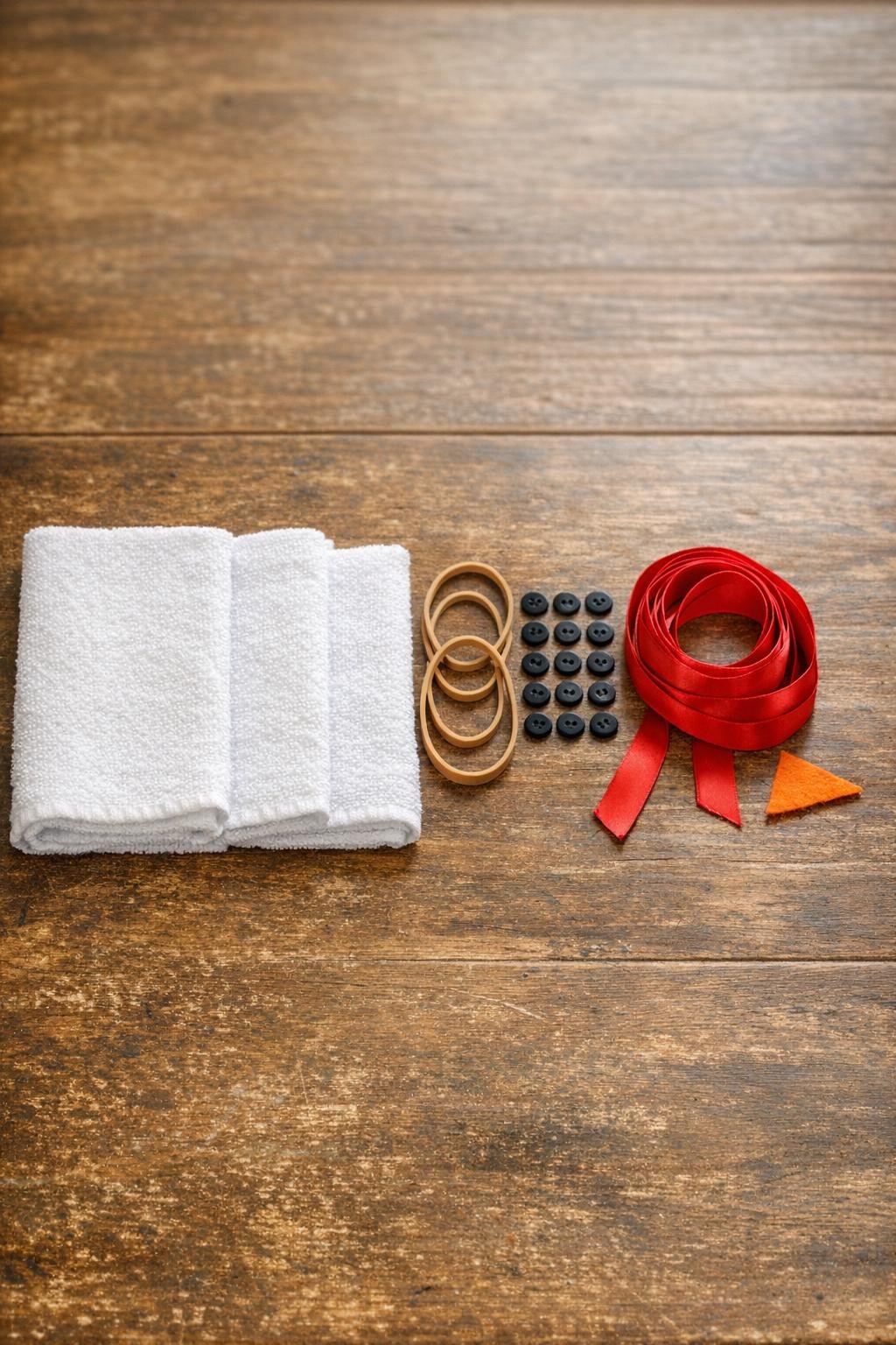 Materials for the rolled washcloth craft laid out on a table
