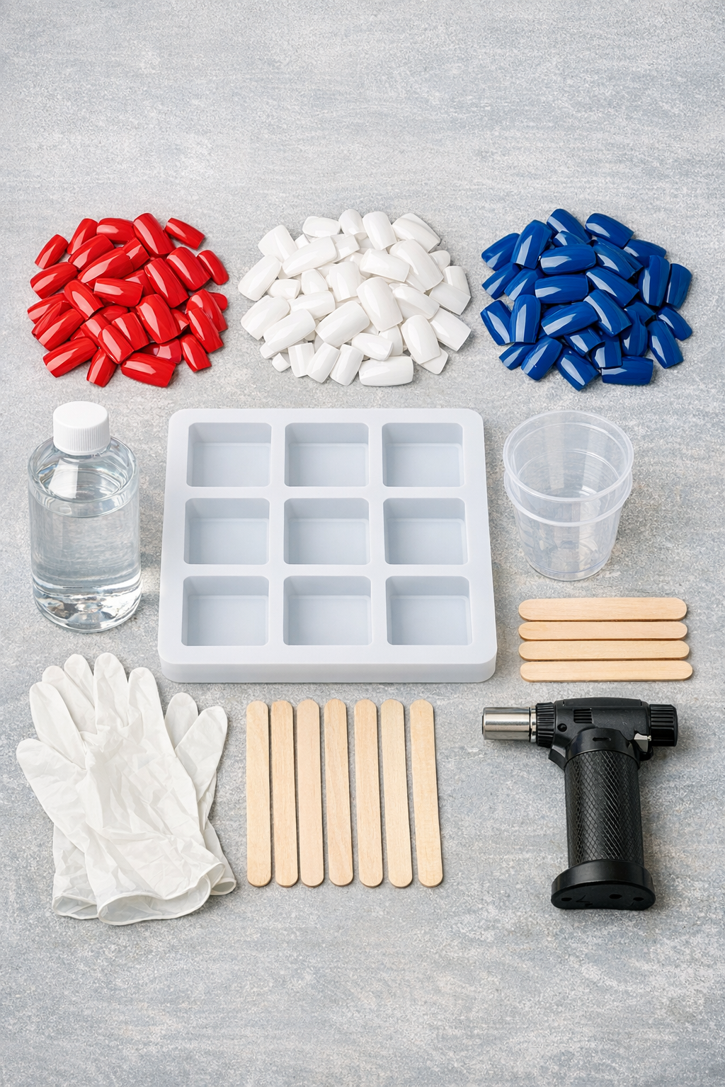 Materials laid out for red, white, and blue artificial fingernail deck tiles