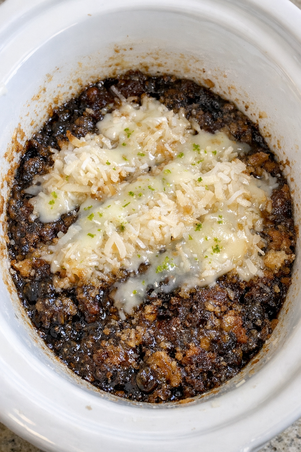 Finished dirty soda cobbler in a white slow cooker