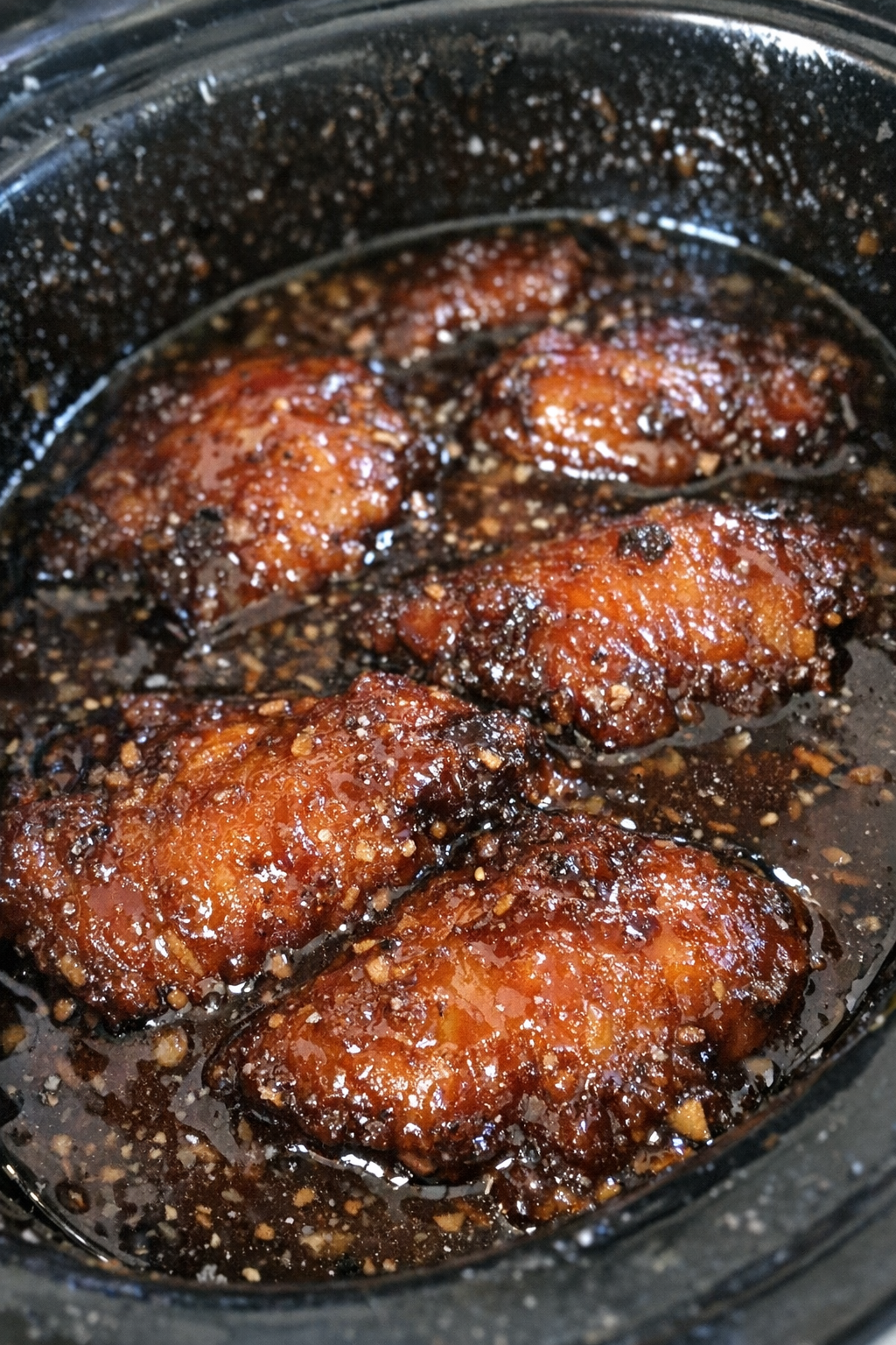 Slow cooker dish with glossy dark amber glaze