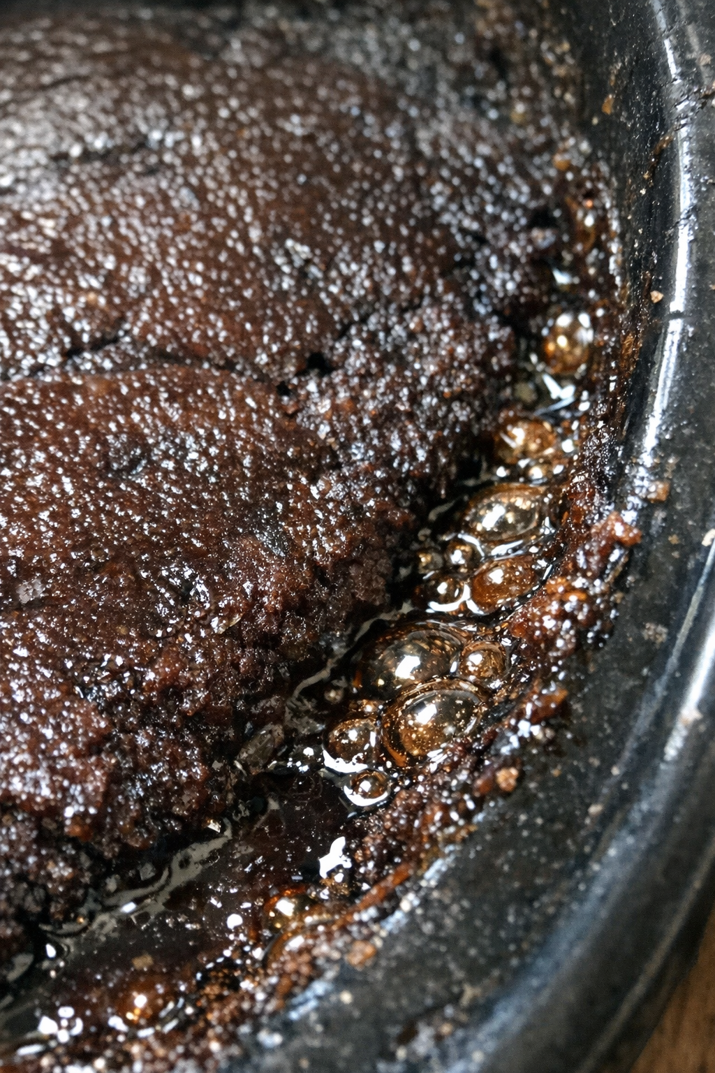 Glistening dark caramelized Texas sheet cake in a slow cooker