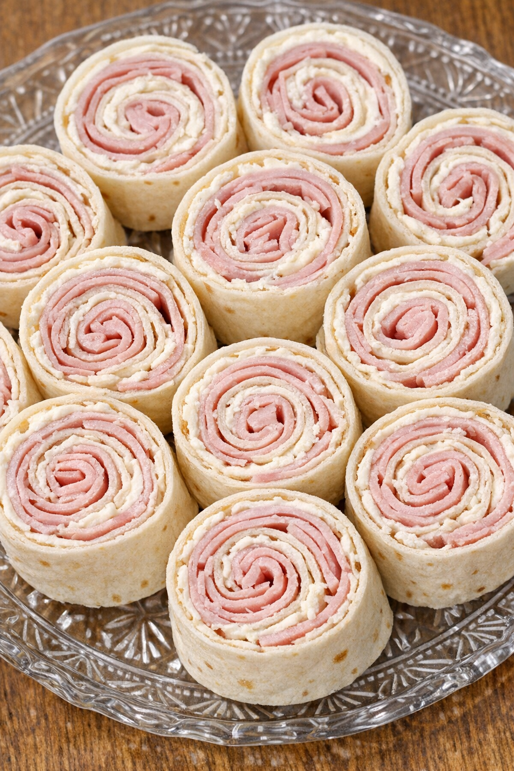 Southern ham and cheese pinwheels on a glass platter