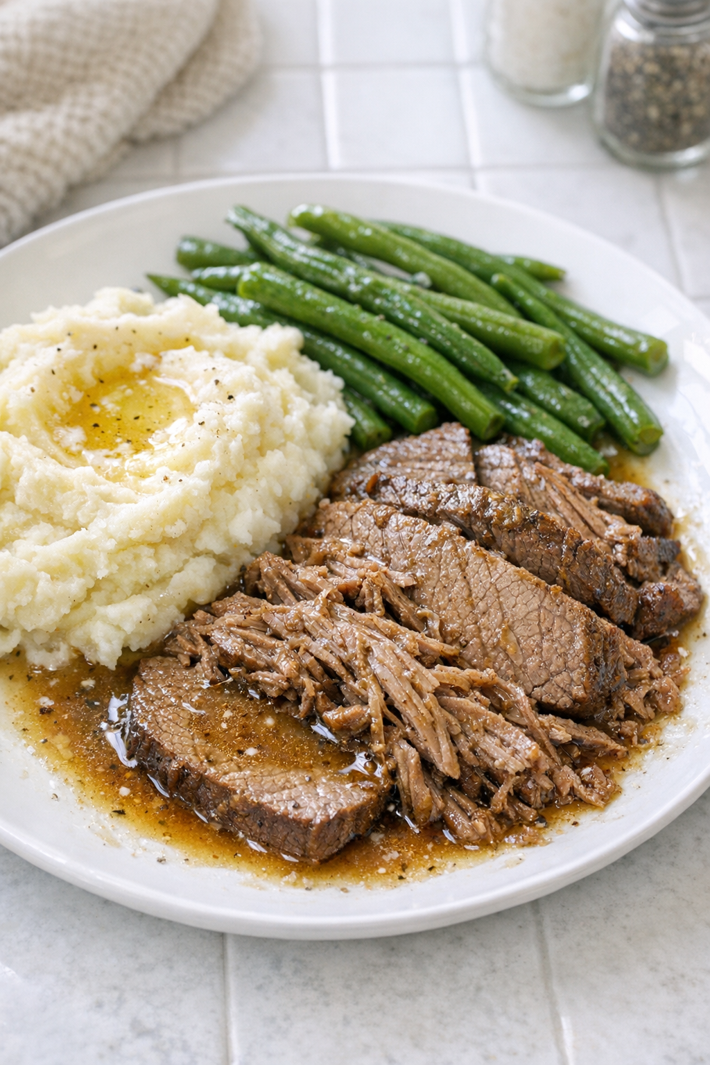 Finished plated pickle juice beef with juices and simple sides