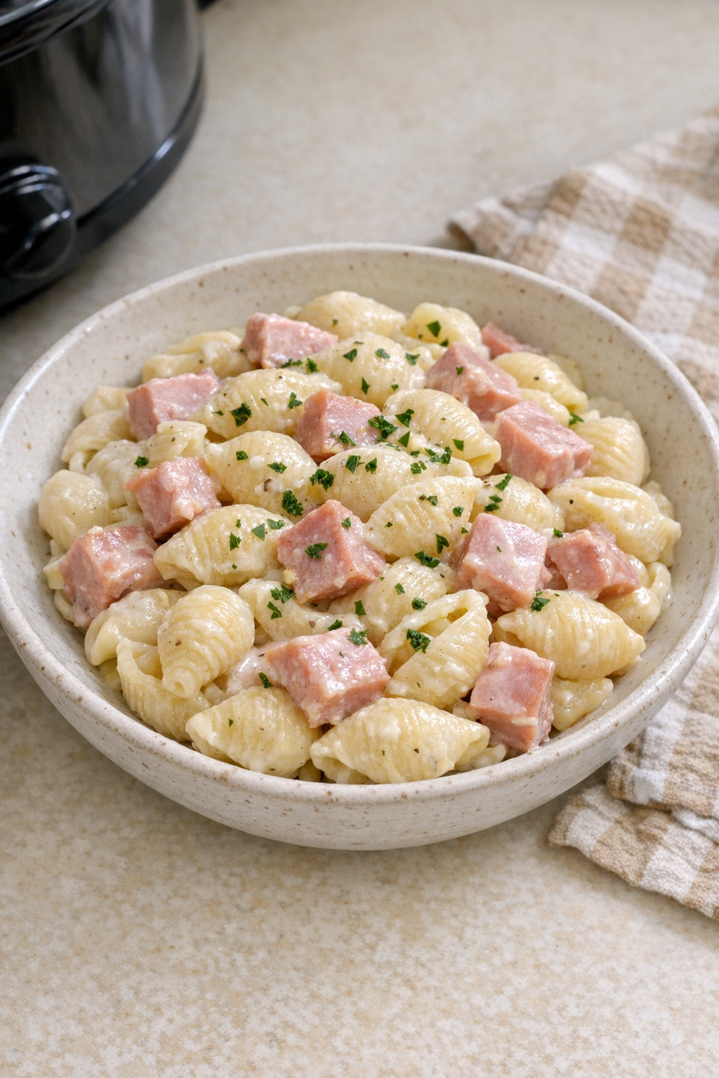 Creamy garlic ham pasta served in a rustic bowl