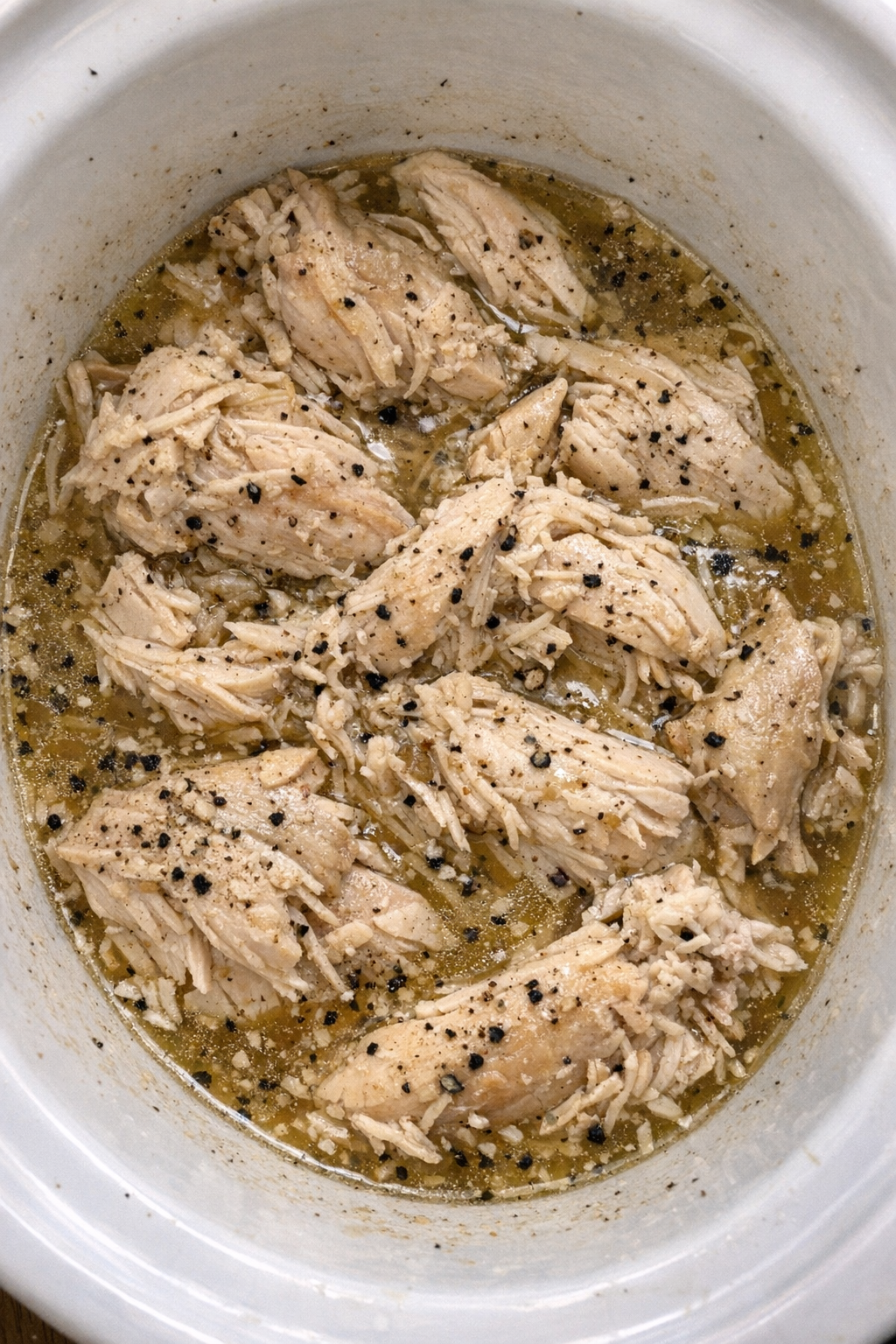 Slow cooker Amish vinegar chicken in a white slow cooker