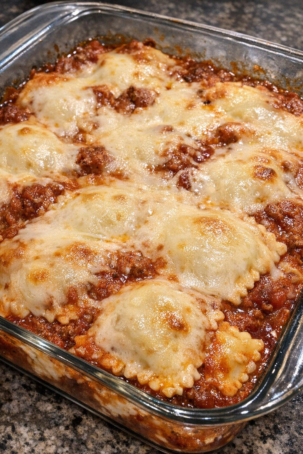 Baked ravioli lasagna with melted cheese and red sauce