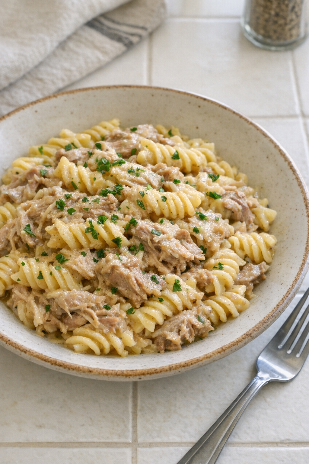 Finished Amish onion powder pork pasta plated in a rustic bowl