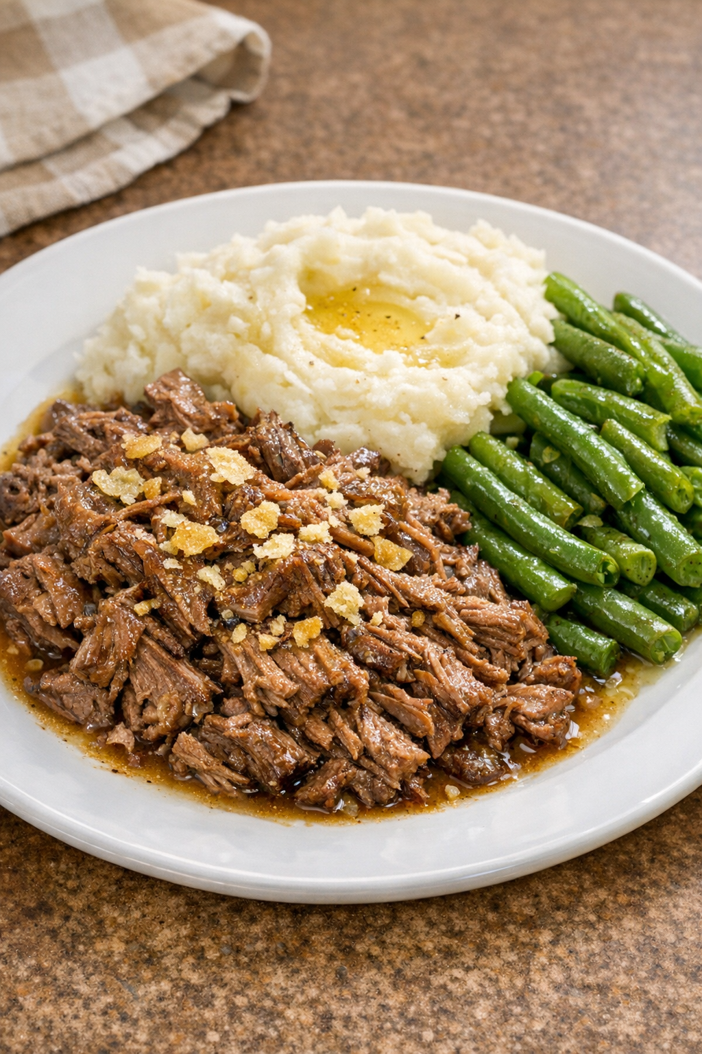 Finished plated salt and vinegar shredded beef with potatoes