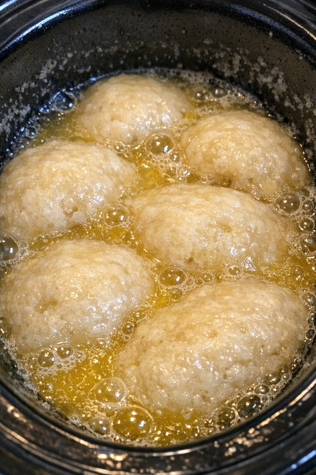 Spongy pale ivory mounds in lemon-yellow syrup in a slow cooker