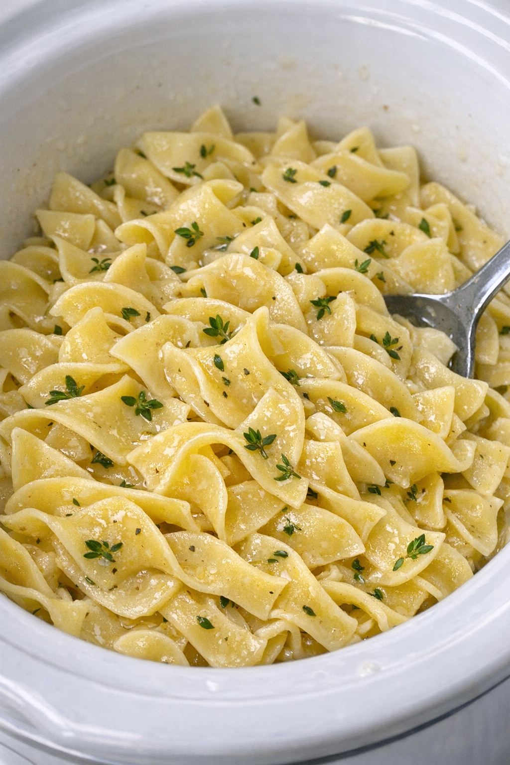 Slow cooker Amish thyme noodles in a white slow cooker